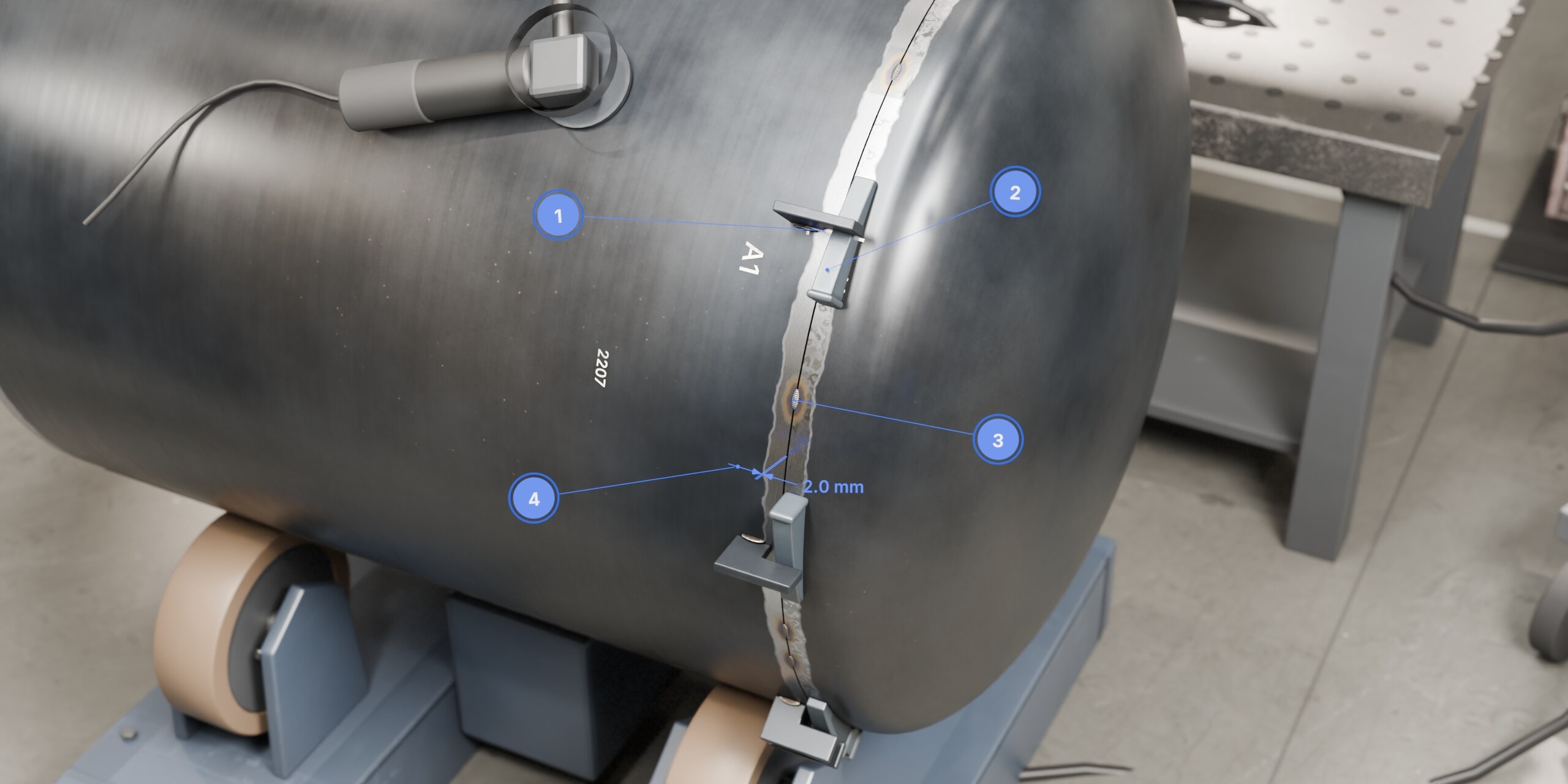 Close-up of a head being fitted to a steel shell on turning rolls, held by dogs and wedges, with numbered markers on the match mark, a dog, a tack weld and the 2.0 mm root gap.